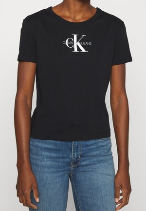 Schwarzes Baumwoll-T-Shirt mit Rundhalsausschnitt, kurzen Ärmeln und einem weißen "CK"-Logo mit dem Drucktext "CALVIN KLEIN JEANS" auf der Vorderseite.