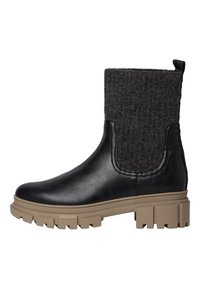Botte cheville en cuir noir avec partie supérieure en laine grise, dotée d'une épaisse semelle en caoutchouc beige avec un motif de semelle robuste et d'une languette à l'arrière.
