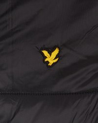 Tissu noir avec un logo de bird brodé jaune au centre. La texture est lisse avec des coutures visibles le long des bords.