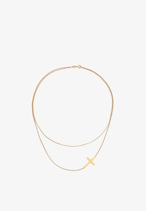 Guldmetal halskæde med to lagkæder. Den ene kæde har et mat korsvedhæng. Glat tekstur og minimalistisk design.