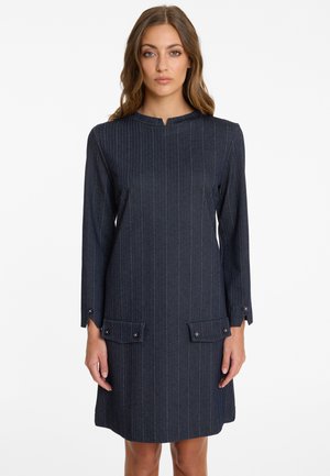 Navy blue pinstriped dress featuring a high neckline, long sleeves, and two front pockets with button accents. Made of textured fabric.