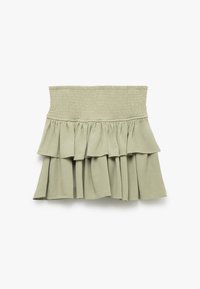 Jupe tiered vert clair avec une taille smockée. Fabriquée en tissu doux, elle présente des couches volantées pour un aspect texturé. Design simple et décontracté.