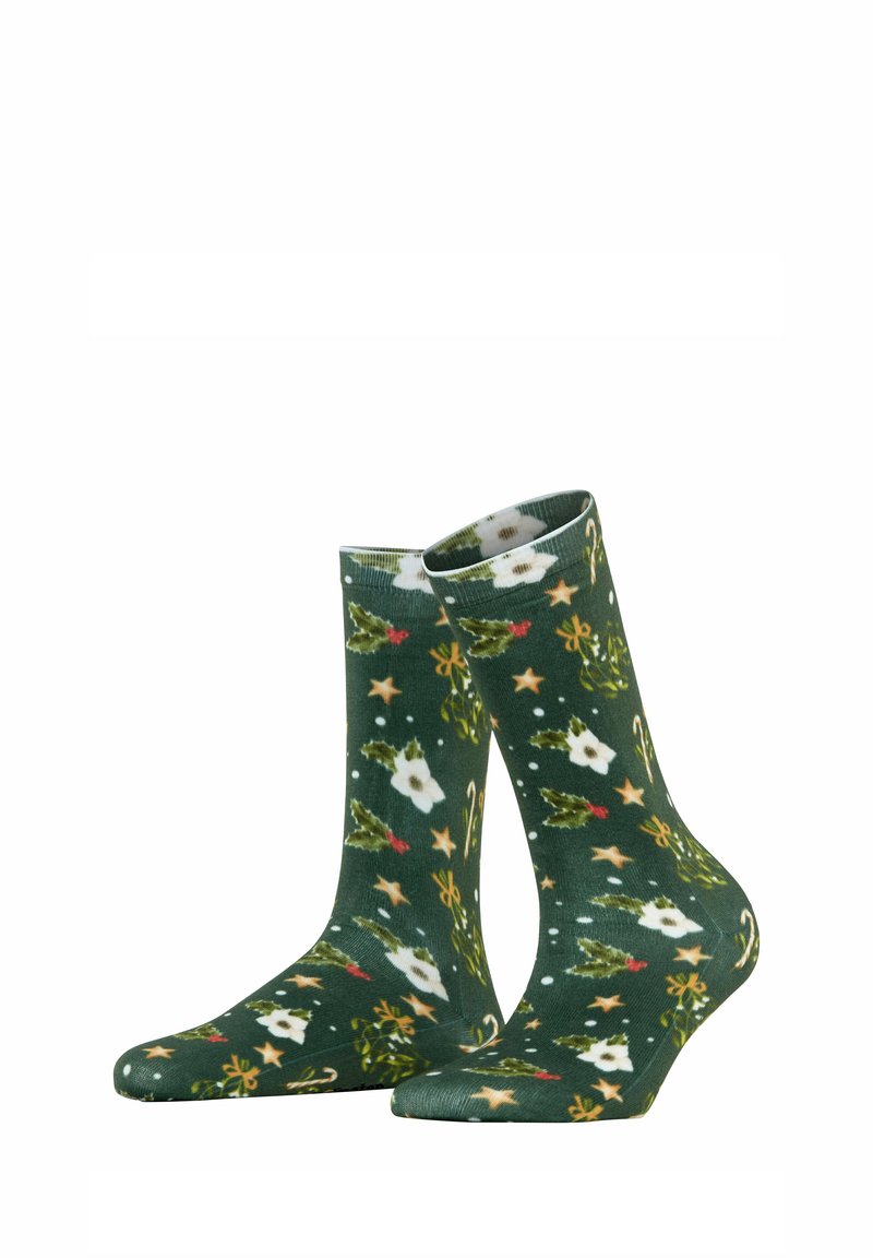 Calzini verdi con un motivo floreale e festivo, caratterizzati da fiori bianchi, stelle, agrifoglio e bastoncini di zucchero. Realizzati in tessuto morbido e elastico.