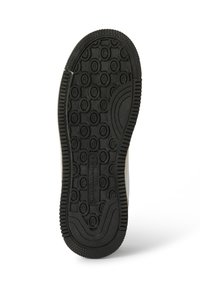 Black rubber sneaker sole with circular tread patterns and brand name embossed in the center, on a white background.