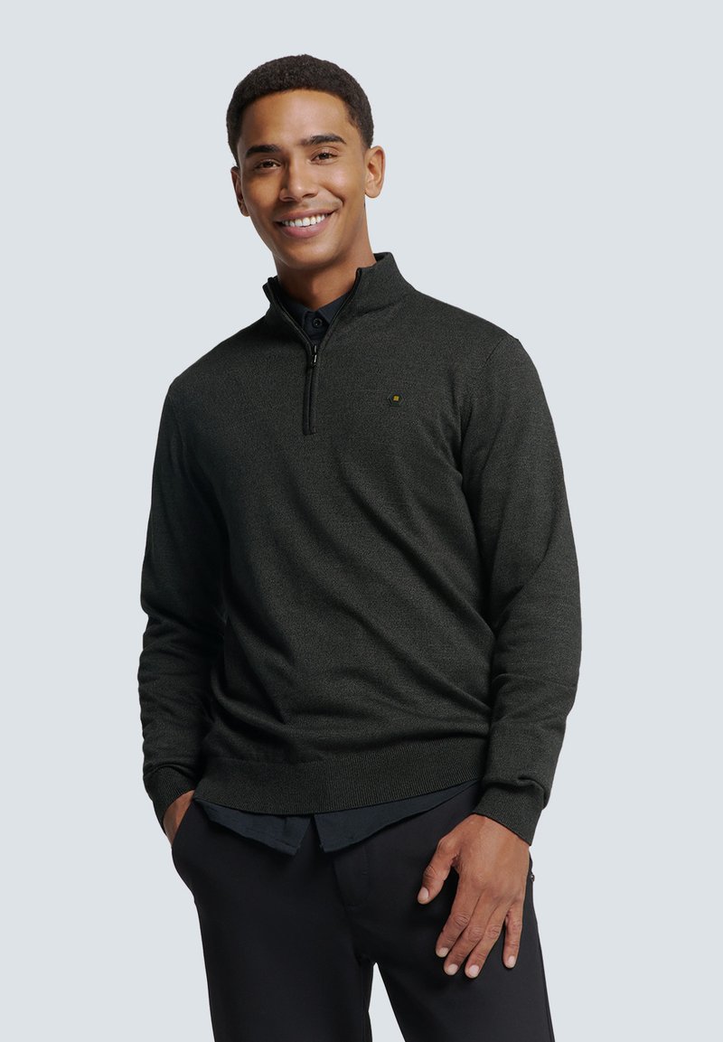 Donkergrijze zip-up trui van een textuurstof, met geribde manchetten en zoom, voorzien van een klein merkelogo op de linkerkant van de borst. Draag boven een blouse met kraag.