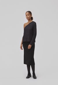 Black long-sleeve, one-shoulder top paired with a black pencil skirt. Smooth texture, simple design, and minimalist style. Black footwear completes the outfit.
