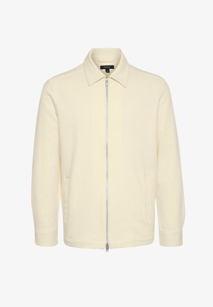 Cremfarbener Blazer mit spitzem Kragen, durchgehendem Reißverschluss und seitlichen Taschen; aus einem strukturierten Stoff mit glatter Oberfläche gefertigt.