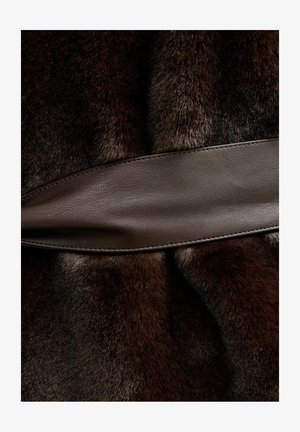 Brown fur with a soft texture, joined by a smooth brown leather band, creating a layered design. The leather accents is rectangular and flat.