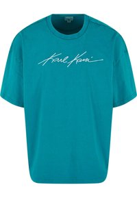 Tīkla krāsas kokvilnas T-krekls ar brīvu piegriezumu, apaļu kakla izgriezumu, īsām piedurknēm un balto izšuvumu "Karl Kani" uz priekšpuses.