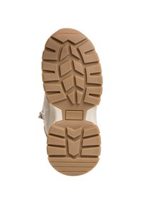 Semelle de chaussure beige clair avec un motif de semelle proéminent, comportant des rainures profondes pour l'adhérence et une surface texturée pour la stabilité.