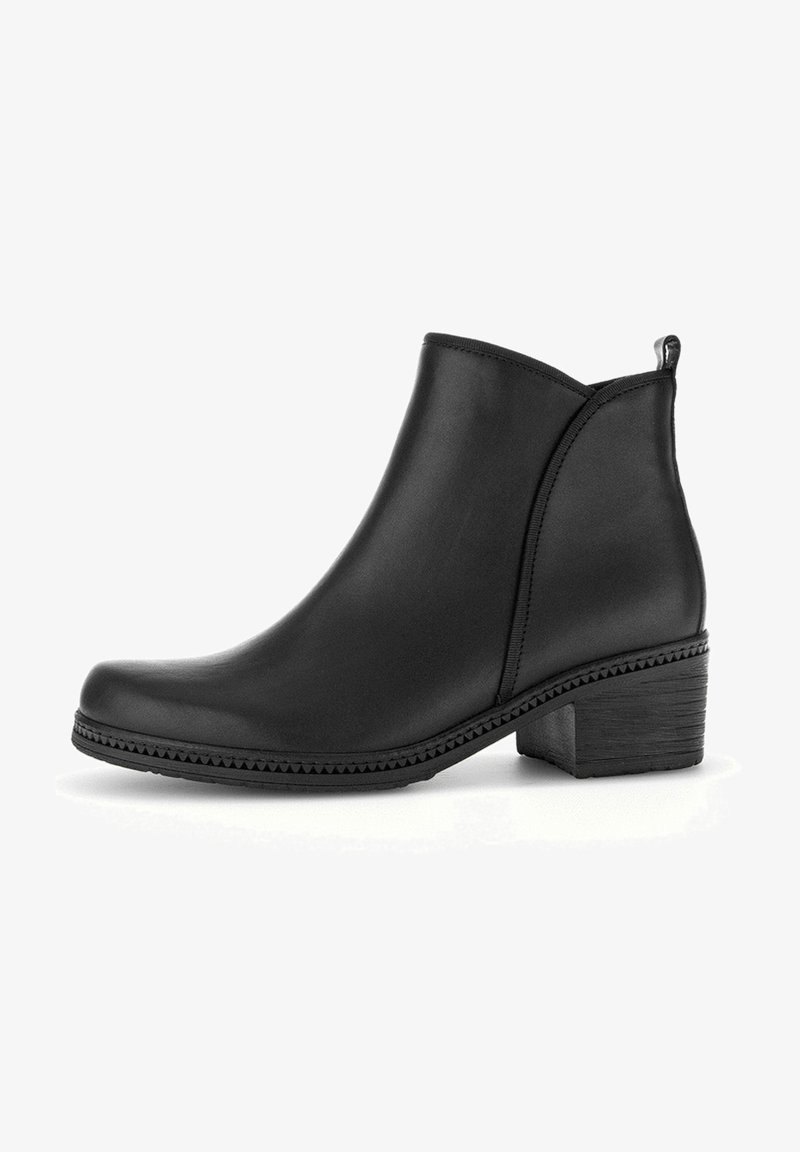 Bottines en cuir noir avec bout arrondi, talon bas empilé, panneaux latéraux élastiques et surpiqûres décoratives le long de la semelle.