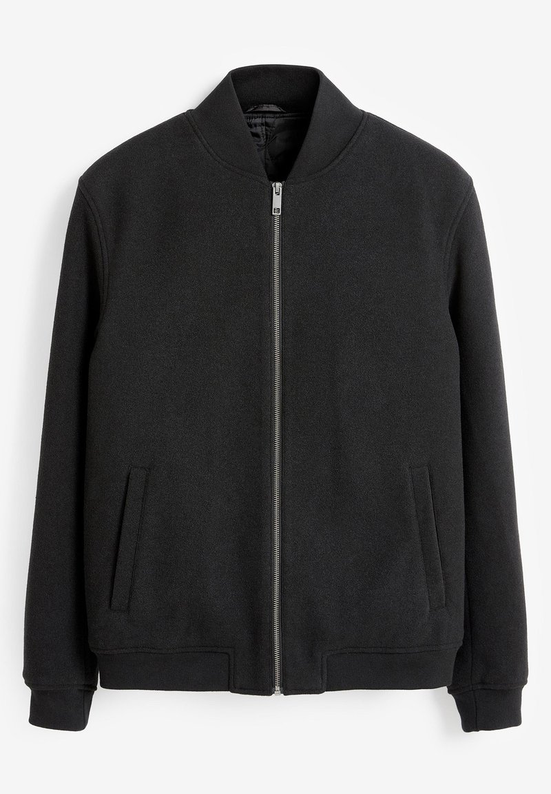 Bomber jacket in black, made of soft fabric. Features a zip front, stand-up collar, and two side pockets with ribbed cuffs and hem.