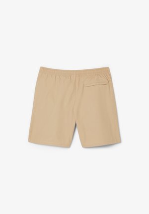 Beige swim shorts with an elastic waistband, featuring a single back pocket and smooth fabric texture. Classic, straight cut design.