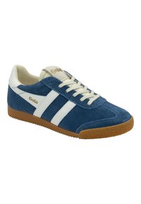 Blue suede sneaker with white stripes, textured gum rubber sole, rounded toe, and lace-up closure. Gold logo on tongue.