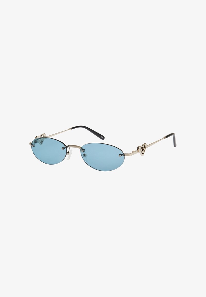 Lunettes de soleil ovales sans monture teintées de bleu, avec des branches fines en métal doré ornées d'un petit détail en forme de cœur et des embouts noirs.