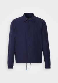 Navy blue windbreaker jacket with a collared neck, front snap buttons, elasticated cuffs, and drawstring hem. Features side pockets.