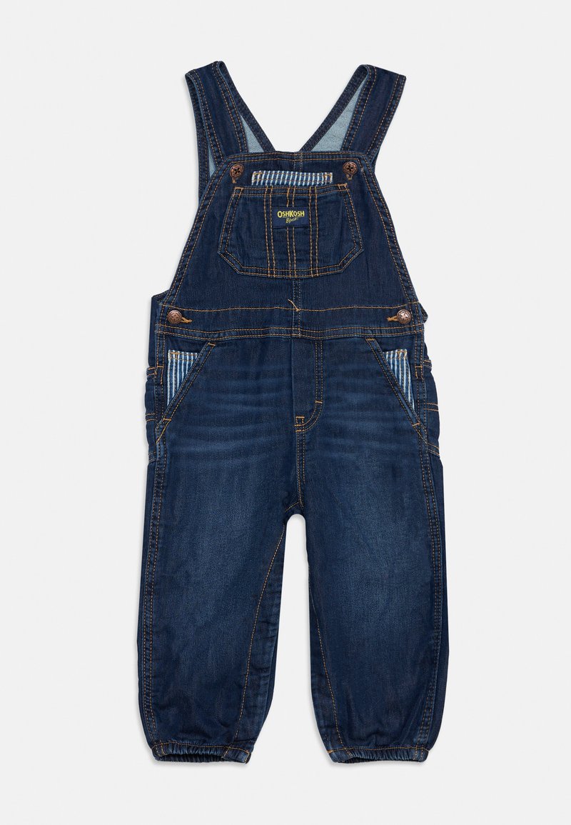 Salopette en denim bleu foncé pour tout-petit avec bretelles réglables, poche avant avec logo jaune, poches latérales avec doublure rayée et chevilles élastiquées.