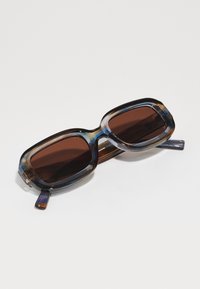 Oversized sunglasses with a multi-colored acetate frame and dark brown lenses. Features rounded rectangular shape and thick arms.