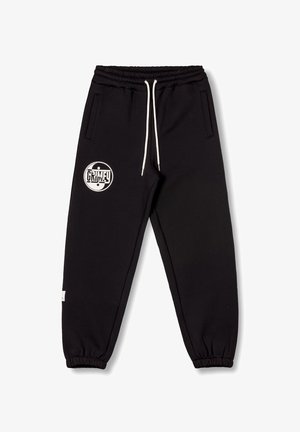 Black jogger pants made of soft fabric, featuring an elastic waistband with drawstrings, side pockets, and a white logo on the left thigh.