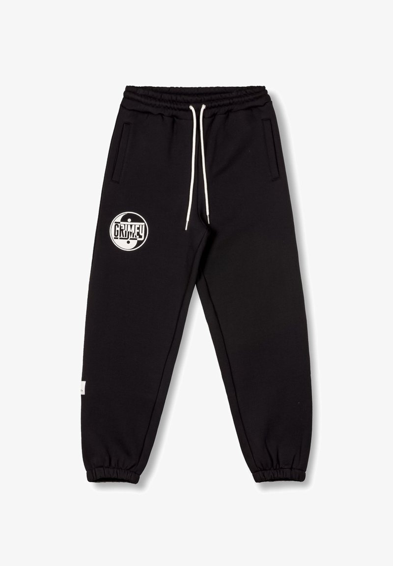 Zwarte joggingbroek van zacht materiaal, met een elastische tailleband met trekkoord, zijzakken en een wit logo op de linker bovenbeen.
