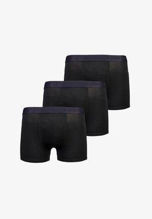 Zwarte boxershorts in een verpakking van drie. Zachte stof met een gladde tailleband waarop het logo "JUNK de LUXE" staat. Middenhoogte pasvorm.
