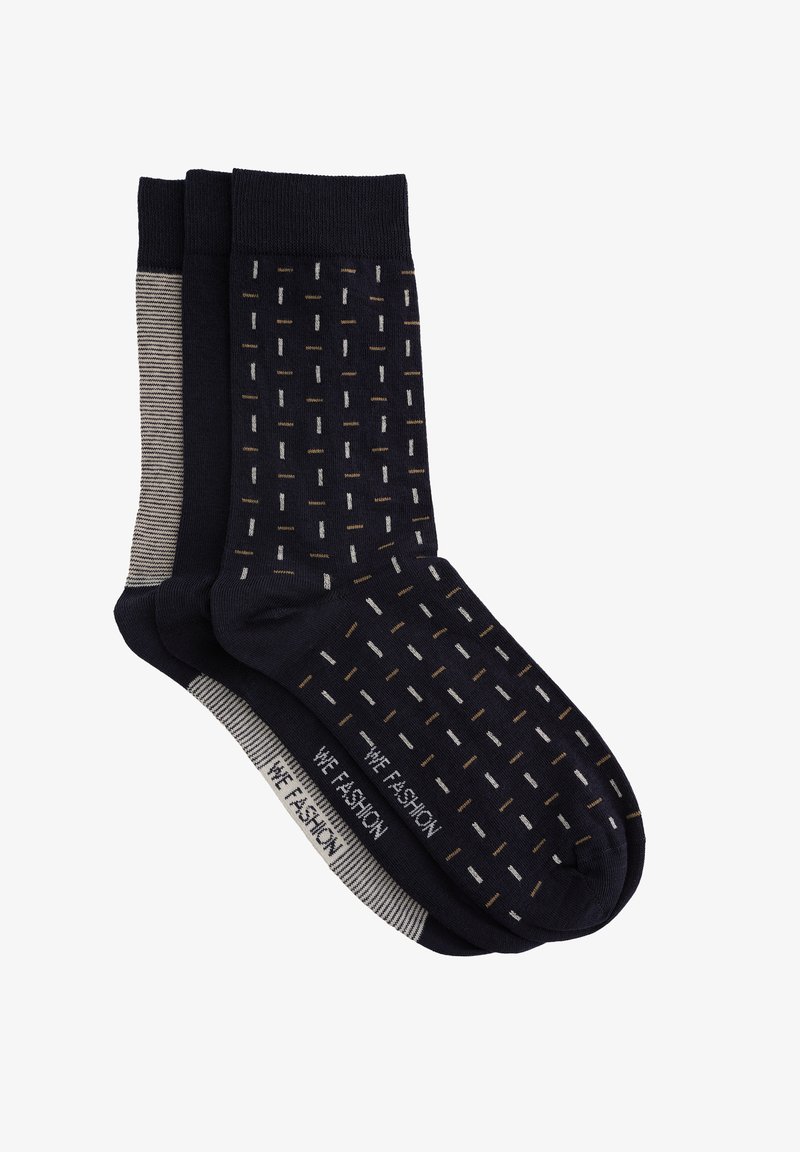 Három pár sötétkék zokni, melyek mintás dizájnnal rendelkeznek, világosszürke és arany hangsúlyokkal. Pamutkeverék anyagú, bordázott szegéllyel.