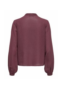 Blouse bordeaux à manches longues avec un design texturé à pois, poignets boutonnés et un col. Fabriquée en tissu léger et semi-transparent.