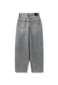 Jeans de mezclilla gris con un corte relajado, que presentan un diseño de cinco bolsillos, costuras visibles y un parche de cuero negro en la parte posterior de la cinturilla.