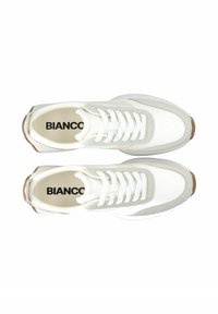 Weiße Sneaker aus Wildleder und Mesh-Material, runde Spitze, flache Schnürsenkel und eine hellbraune Gummisohle. Markennamen "BIANCO" innen aufgedruckt.