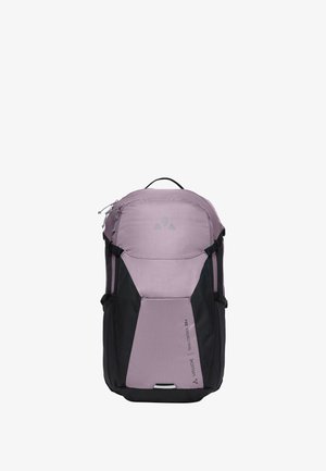 Mochila de senderismo en púrpura claro y negro con asa superior, múltiples compartimentos y el logo "VAUDE Trail Control 20+" en el panel frontal.