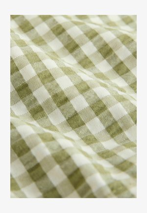 Tissu à carreaux vert et blanc avec une texture douce, présentant un motif vichy classique. Les carrés sont de taille uniforme et tissés.