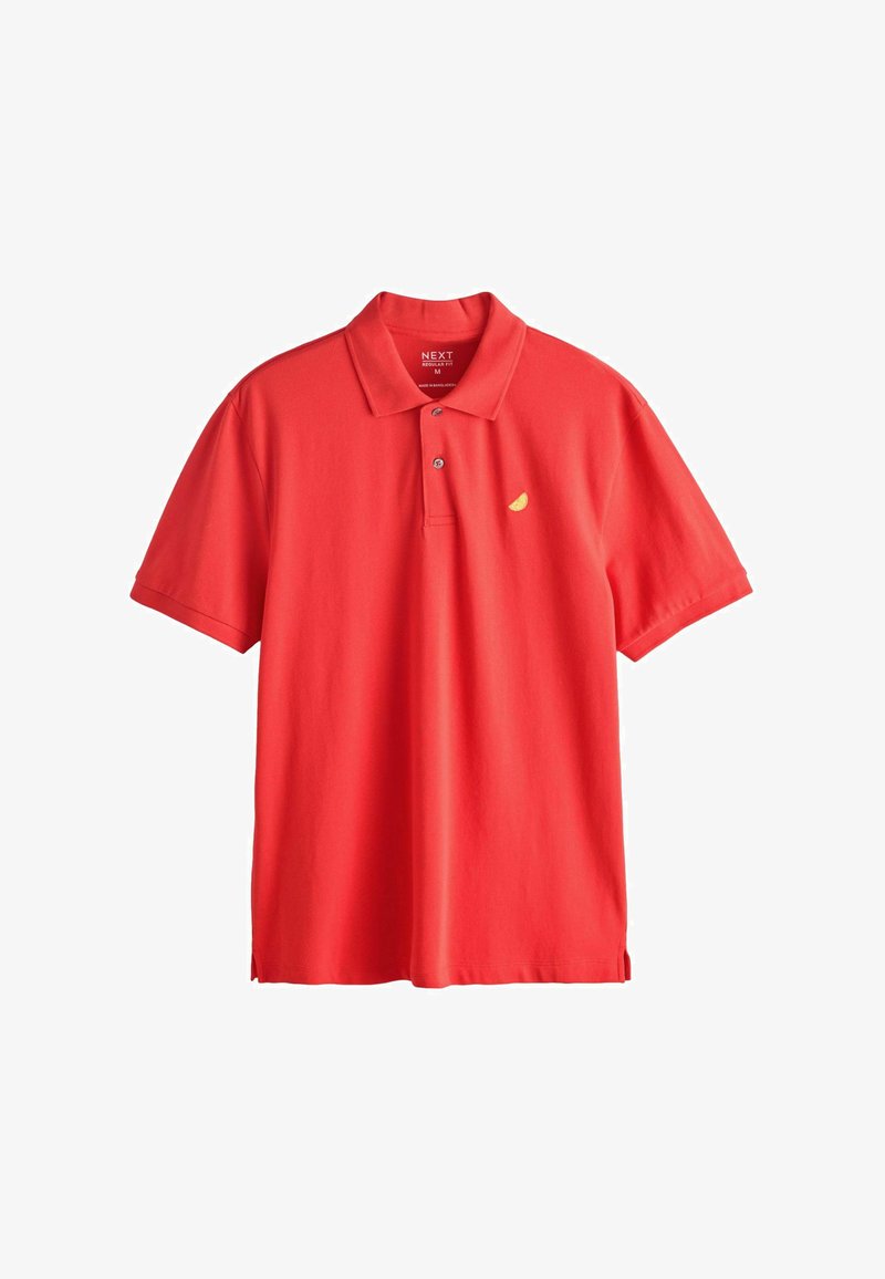 Polo rouge à manches courtes avec deux boutons et un petit logo en forme de tranche de citron jaune sur le côté gauche de la poitrine.