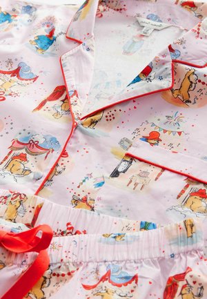 Cotton pajama set featuring a light pink base with colorful animal illustrations, red piping, and an elastic waistband with a tied ribbon.