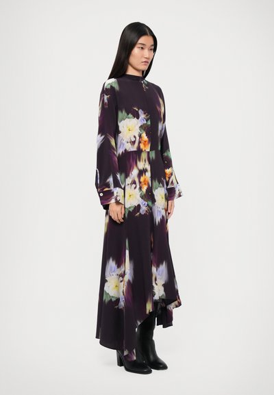 Long-sleeved, high-neck purple dress adorned with vibrant floral patterns, featuring a flowing, asymmetrical hem and buttoned cuffs.