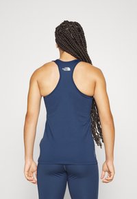 Navy blue athletic tank top with a scoop neckline, racerback design, and the logo of The North Face on the upper back. Smooth texture.
