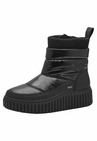 Bottines noires étanches, dotées d'une finition brillante en vernis, d'une semelle striée et d'une bordure supérieure tricotée. Détail du logo S. Oliver sur le côté.