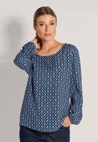 Blue patterned blouse with a wide rounded neckline, long sleeves, and a loose fit. Features a diamond design in shades of blue and white.