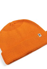 Knitted orange beanie hat with a folded ribbed cuff, featuring a small logo tag on the side and a textured finish throughout.
