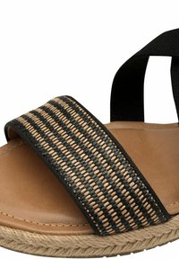 Brown sandal with a black woven strap featuring a textured pattern. Includes a natural rope sole for added grip and durability.