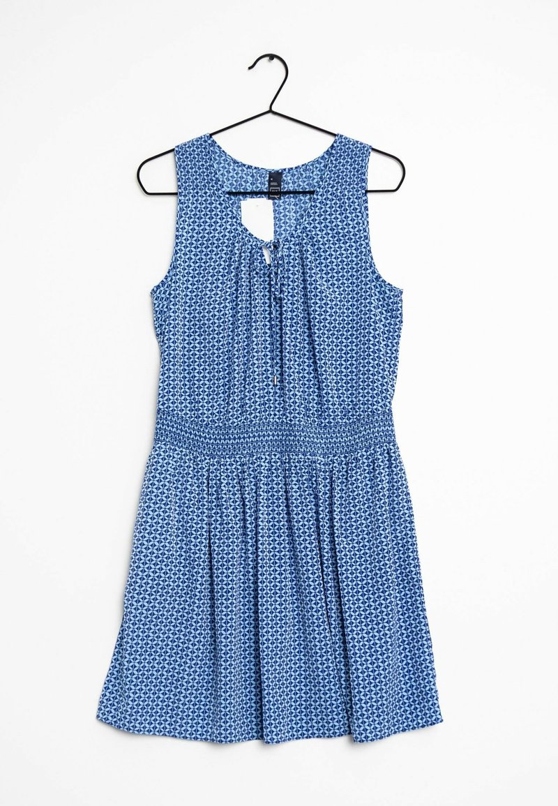 Robe bleu sans manches avec un motif géométrique, dos à découpe en forme de goutte, taille élastique et jupe évasée. Confectionnée dans un tissu léger.