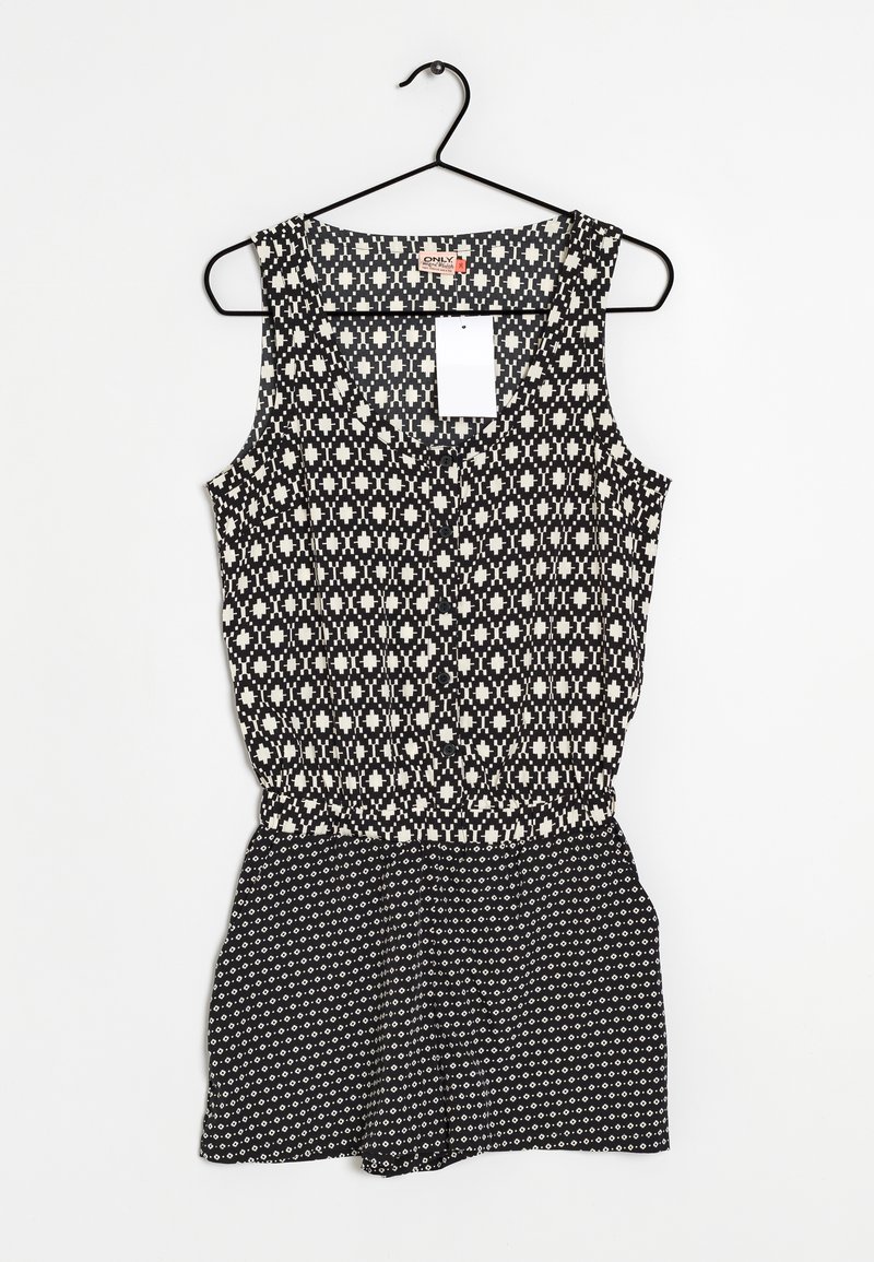 Combinaison sans manches noir et blanc présentant un motif géométrique sur le haut, avec une taille froncée et une partie inférieure en short texturée et à motif.