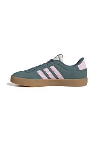 Låg sneakers i teal mocka med rosa ränder och hälla, gummisulor och mörk teal snörning, visad i sidoprofil.