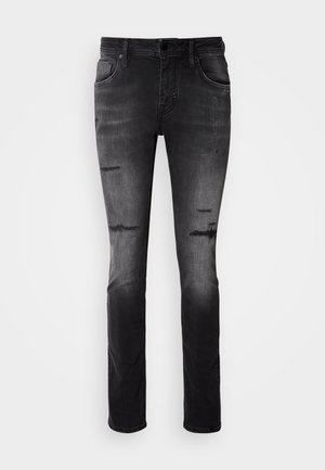 Jeans in denim nero con un design aderente, caratterizzati da dettagli scuciti e una superficie liscia. Stile a cinque tasche con zip e chiusura a bottone.