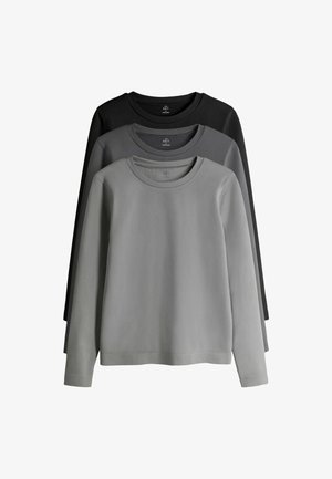 Zestaw trzech koszulek z długim rękawem w różnych odcieniach szarości i czerni. Każda koszulka ma okrągły dekolt i miękką fakturę materiału.