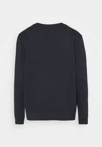 Sudadera de color azul marino hecha de algodón, con cuello redondo, mangas largas, puños de canalé y un diseño liso sin patrones ni adornos.