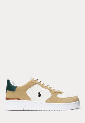 Baskets basses en daim beige et panneaux en cuir blanc, lacets blancs, languette de talon vert foncé et logo Polo Ralph Lauren sur le côté.