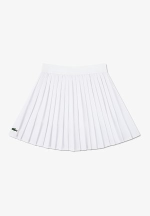 White pleated skirt with an elastic waistband, featuring a small green embroidered logo on the lower hem.