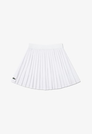White pleated skirt with an elastic waistband, featuring a small green embroidered logo on the lower hem.