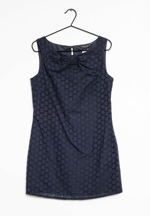 Abito senza maniche blu navy con un motivo testurizzato a cerchi, caratterizzato da un dettaglio a fiocco sul colletto e un piccolo apertura sul retro.