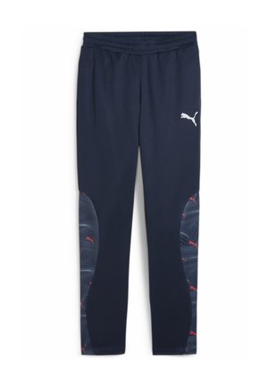 Pantalons de sport bleu marine en tissu doux, avec une taille flexible, des panneaux latéraux à motif de vagues en gris et rouge, et un logo blanc.